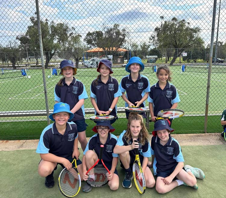 The state 2 tennis team pose for a group photo.