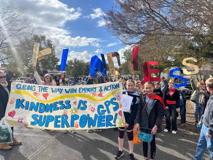 students in the parade with a sign