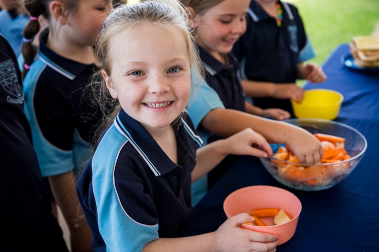 A child enjoys a bowl of fruit during crunch and sip.